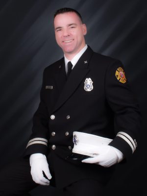 Portrait of man in fire captain’s uniform